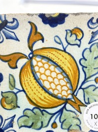 Two small polychrome Dutch Delft 'pomegranates' and 'tulips' tiles, ca. 1600