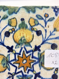 Two small polychrome Dutch Delft 'pomegranates' and 'tulips' tiles, ca. 1600