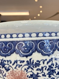 A fine Chinese blue, white and copper-red 'lotus scroll' fish bowl, Qianlong