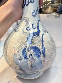 A Chinese blue, white and copper-red garlic-mouth vase with mythical animals, Kangxi mark, 19th C.
