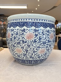 A fine Chinese blue, white and copper-red 'lotus scroll' fish bowl, Qianlong
