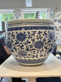 A massive Chinese blue and white 'lotus scroll' fish bowl, Qianlong/Jiaqing