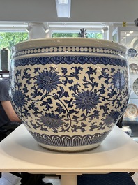 A massive Chinese blue and white 'lotus scroll' fish bowl, Qianlong/Jiaqing