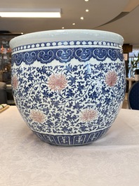 A fine Chinese blue, white and copper-red 'lotus scroll' fish bowl, Qianlong