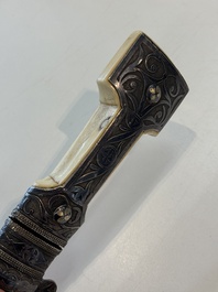 A Caucasian walrus bone-hilted kindjal with niello silver mounts, 19th C.