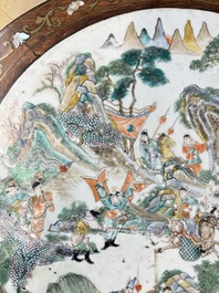 A Chinese mother-of-pearl-inlaid hongmu table with a circular Canton famille verte 'warriors on horseback' plaque, 19th C.