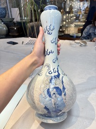 A Chinese blue, white and copper-red garlic-mouth vase with mythical animals, Kangxi mark, 19th C.