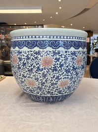 A fine Chinese blue, white and copper-red 'lotus scroll' fish bowl, Qianlong