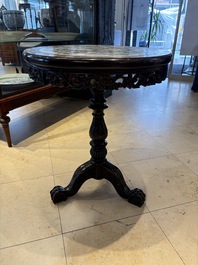 A Chinese mother-of-pearl-inlaid hongmu table with a circular Canton famille verte 'warriors on horseback' plaque, 19th C.