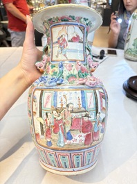 A pair of Chinese famille rose vases with narrative design on wooden stands, 19th C.