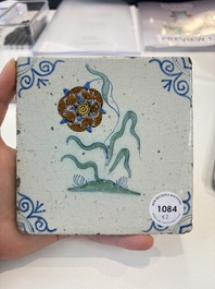Two polychrome Dutch Delft 'flower' tiles, 17th C.