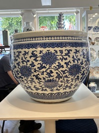 A massive Chinese blue and white 'lotus scroll' fish bowl, Qianlong/Jiaqing
