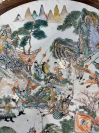 A Chinese mother-of-pearl-inlaid hongmu table with a circular Canton famille verte 'warriors on horseback' plaque, 19th C.