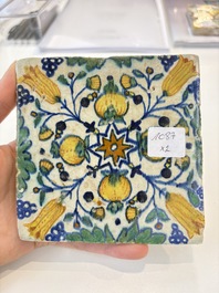 Two small polychrome Dutch Delft 'pomegranates' and 'tulips' tiles, ca. 1600