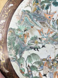 A Chinese mother-of-pearl-inlaid hongmu table with a circular Canton famille verte 'warriors on horseback' plaque, 19th C.