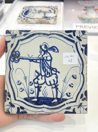Two blue and white Dutch Delft 'soldier with coloured flame' tiles, 17th C.