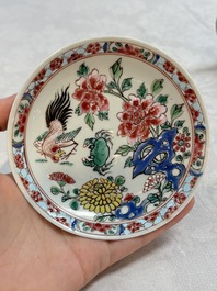 A Chinese famille rose 'roosters' covered teapot and two cups and saucers, Yongzheng