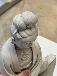 A rare and elegant Chinese Dehua blanc de Chine Guanyin on a wooden stand, Transitional period