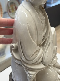 A rare and elegant Chinese Dehua blanc de Chine Guanyin on a wooden stand, Transitional period