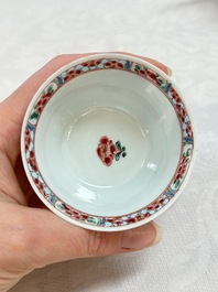 A Chinese famille rose 'roosters' covered teapot and two cups and saucers, Yongzheng