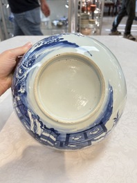 A Chinese blue and white punch bowl with a lady and two boys in a garden, Qianlong