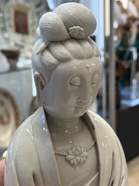 A rare and elegant Chinese Dehua blanc de Chine Guanyin on a wooden stand, Transitional period