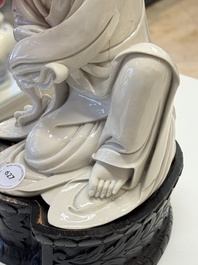 A rare and elegant Chinese Dehua blanc de Chine Guanyin on a wooden stand, Transitional period