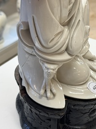 A rare and elegant Chinese Dehua blanc de Chine Guanyin on a wooden stand, Transitional period