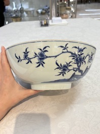 A Chinese blue and white punch bowl with a lady and two boys in a garden, Qianlong
