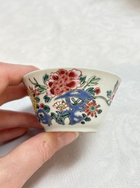 A Chinese famille rose 'roosters' covered teapot and two cups and saucers, Yongzheng