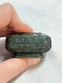 A small Chinese spinach-green jade covered box and two white jade pendants, 18/19th C.