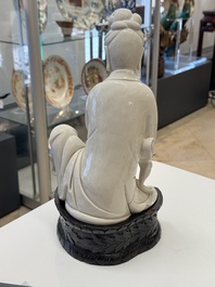 A rare and elegant Chinese Dehua blanc de Chine Guanyin on a wooden stand, Transitional period