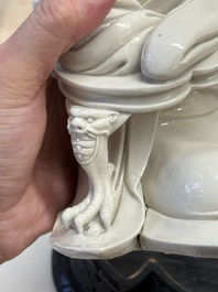 A rare and elegant Chinese Dehua blanc de Chine Guanyin on a wooden stand, Transitional period