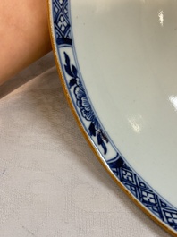 A Chinese blue and white punch bowl with a lady and two boys in a garden, Qianlong
