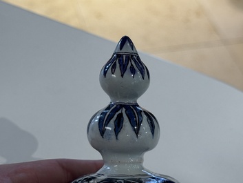 A blue, white and manganese Dutch Delft chinoiserie vase and cover, ca. 1700