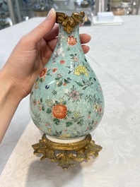 A Chinese wucai square covered container, a gilt bronze-mounted famille verte vase and a Canton famille verte bottle vase, Kangxi and later