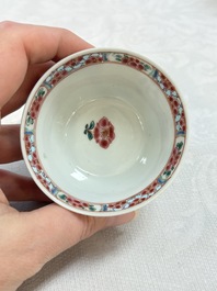 A Chinese famille rose 'roosters' covered teapot and two cups and saucers, Yongzheng