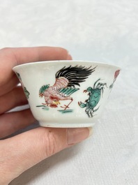 A Chinese famille rose 'roosters' covered teapot and two cups and saucers, Yongzheng