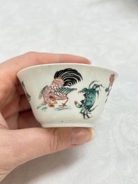 A Chinese famille rose 'roosters' covered teapot and two cups and saucers, Yongzheng