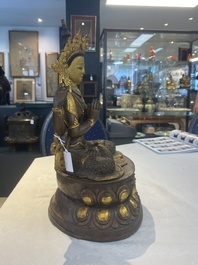 A Tibetan or Nepalese turquoise-inlaid partly-gilt bronze figure of White Tara, 20th C.