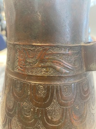 A Chinese archaic bronze inscribed wine vessel with scale design, 'hu 壺', Zhou