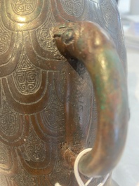A Chinese archaic bronze inscribed wine vessel with scale design, 'hu 壺', Zhou