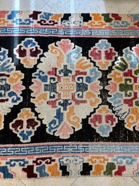 Two Tibetan woollen rugs with floral design, 19th C.