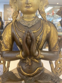 A Tibetan or Nepalese turquoise-inlaid partly-gilt bronze figure of White Tara, 20th C.