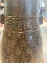A Chinese archaic bronze inscribed wine vessel with scale design, 'hu 壺', Zhou
