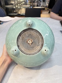 A Chinese celadon-glazed tripod censer with floral anhua design, 18/19th C.