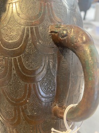 A Chinese archaic bronze inscribed wine vessel with scale design, 'hu 壺', Zhou