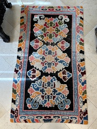 Two Tibetan woollen rugs with floral design, 19th C.