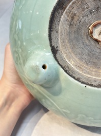 A Chinese celadon-glazed tripod censer with floral anhua design, 18/19th C.