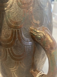 A Chinese archaic bronze inscribed wine vessel with scale design, 'hu 壺', Zhou